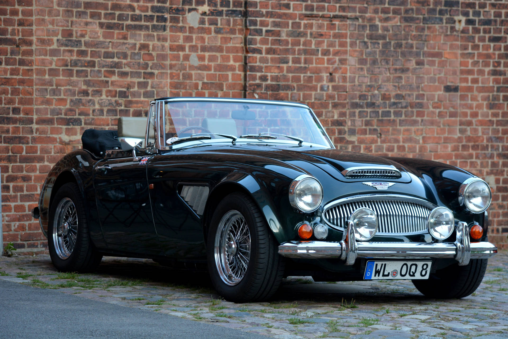A stylish Black British Sports Car on a sunny Sunday. Wallpaper